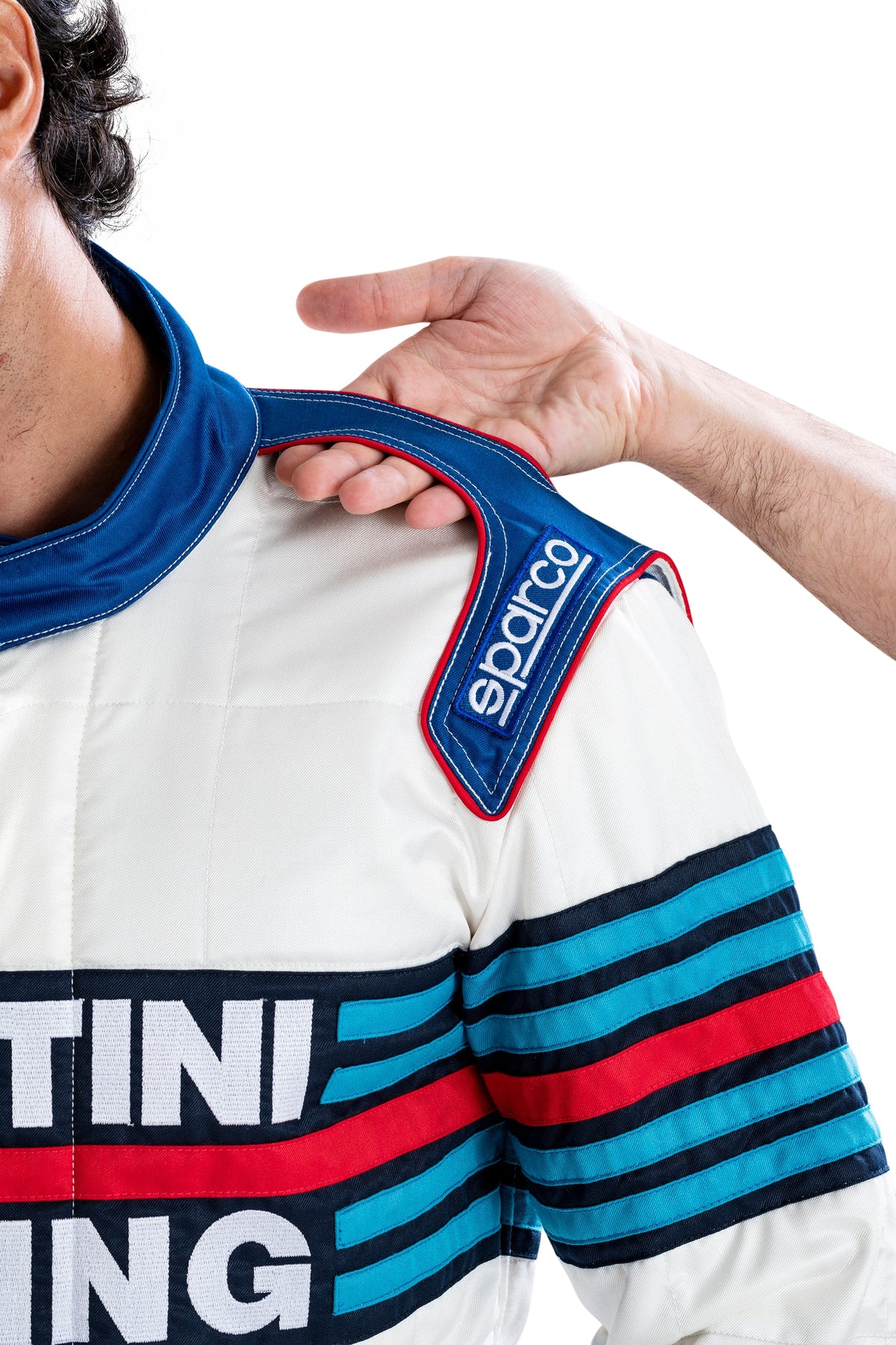 Racing suit collar area with blue trim and sparco patch on white fabric