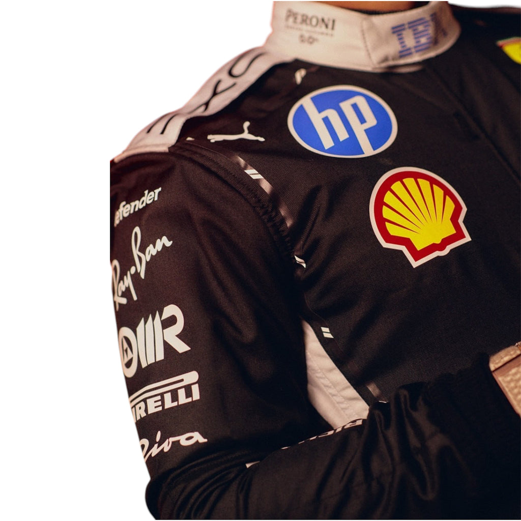 Close-up racing suit chest with Shell logo, HP badge, and white Puma details