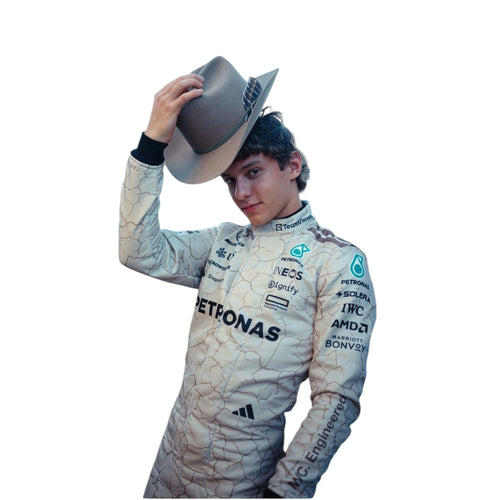 Light blue racing suit with PETRONAS logos and cracked pattern, holding helmet brim
