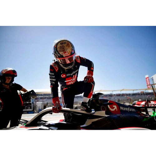 Black racing suit with red and white sponsor graphics and full-length sleeves