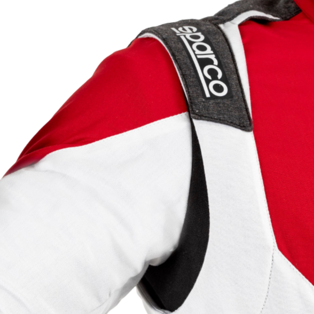 Red and white racing suit close-up with Sparco patch on black-trim collar