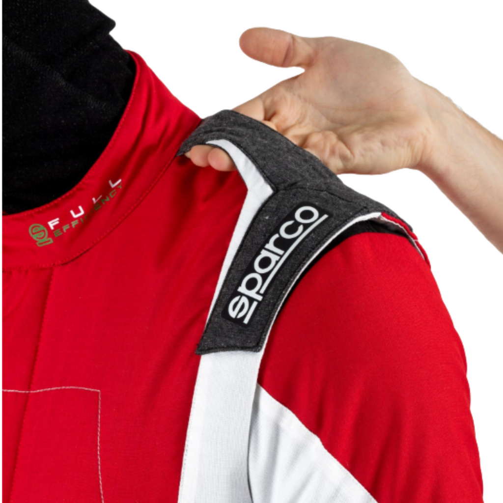 Red racing suit shoulder with Sparco logo patch and black textured trim