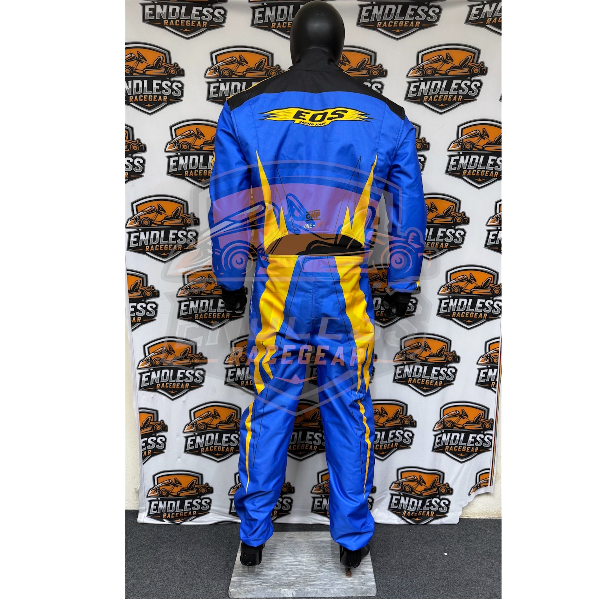 Blue go-kart racing suit with yellow waist, black panels, back on mannequin.