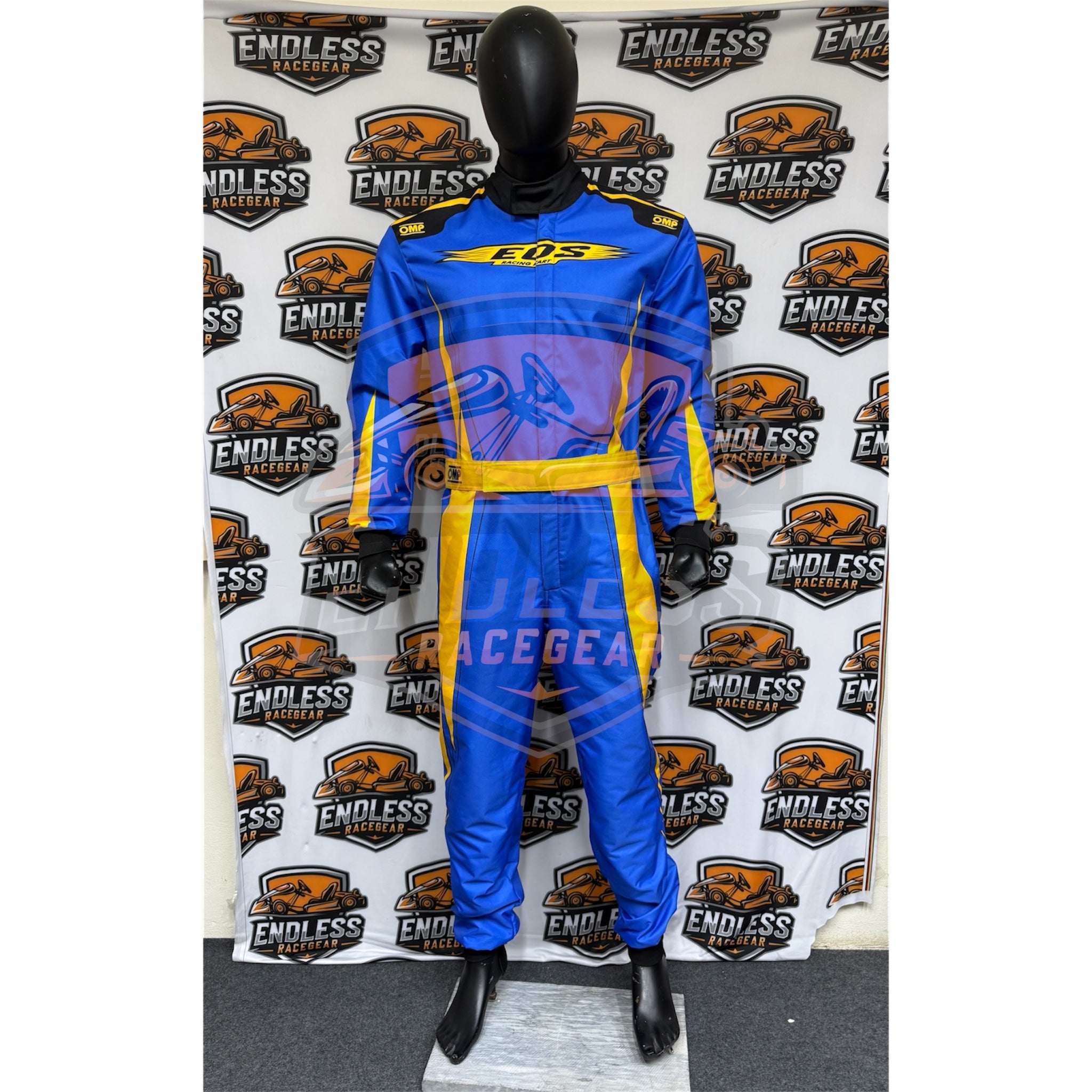 Blue go-kart racing suit with yellow belt stripe, black panels, back view.