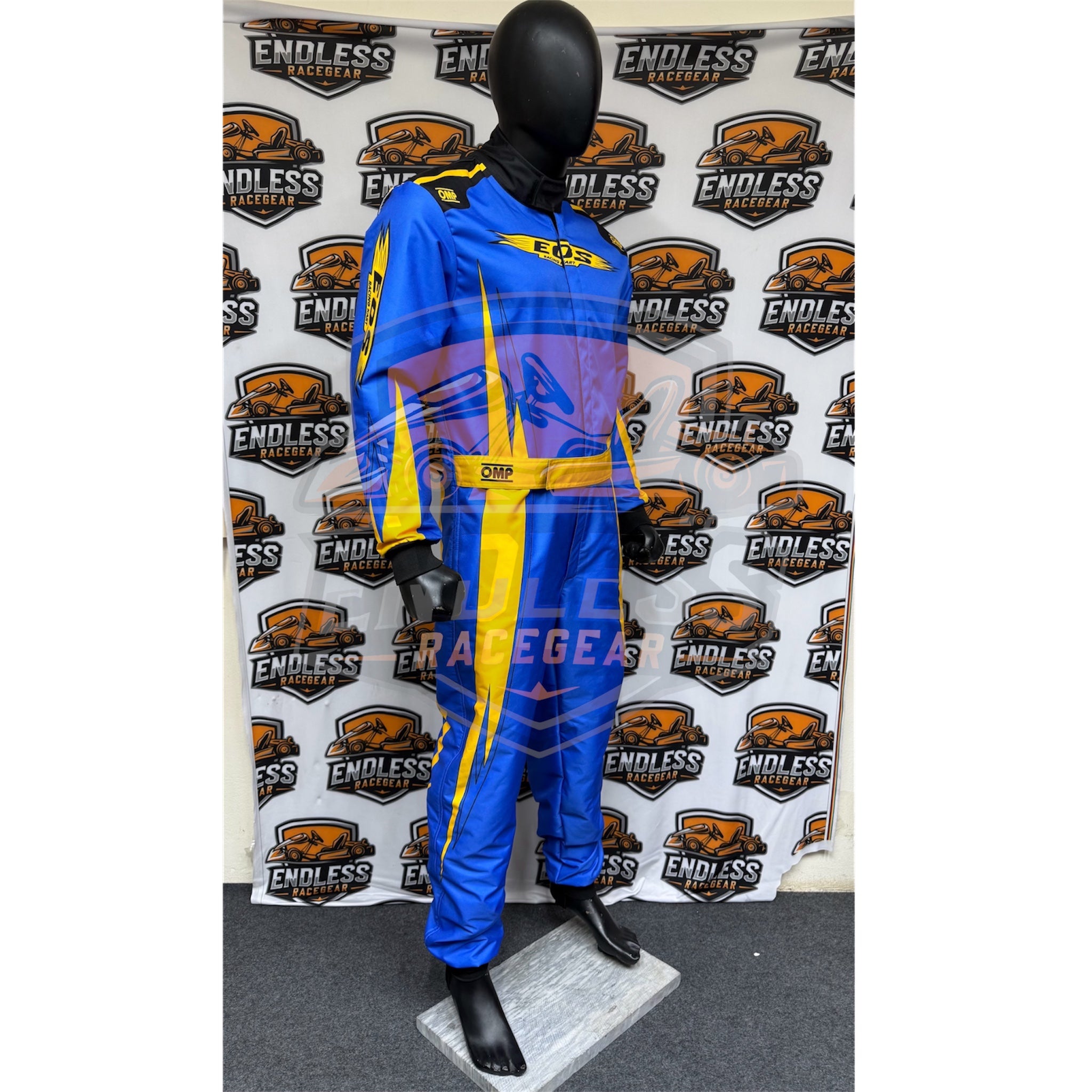 Blue go-kart racing suit with yellow stripes and black trim, three-quarter view.
