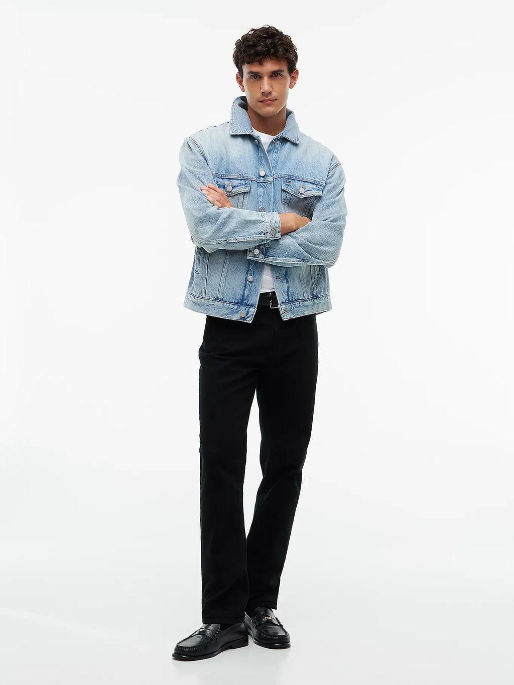 Light blue denim trucker jacket worn open with button-front chest pockets