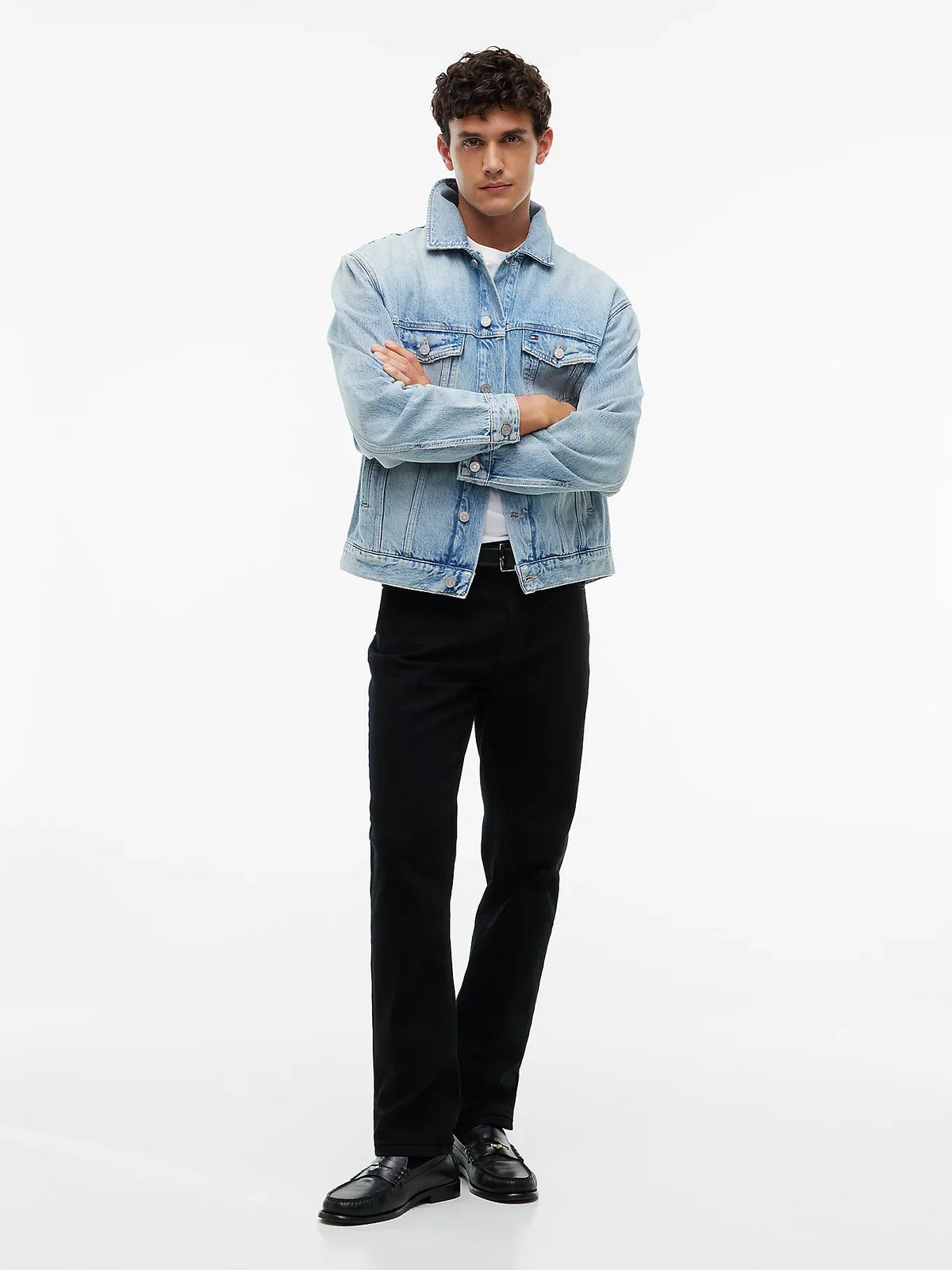 Light blue denim trucker jacket worn open with button-front chest pockets