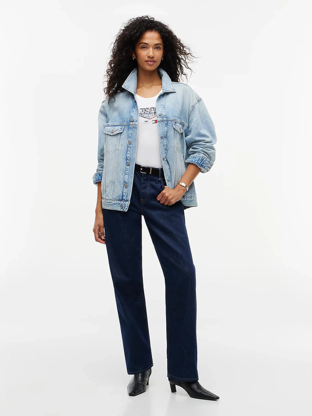 Light blue denim jacket styled open with rolled sleeves and chest flap pockets