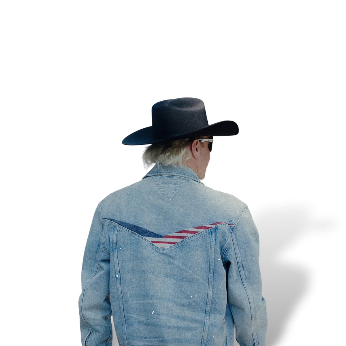Back of a light blue denim jacket with a red, white, and navy V-shaped graphic