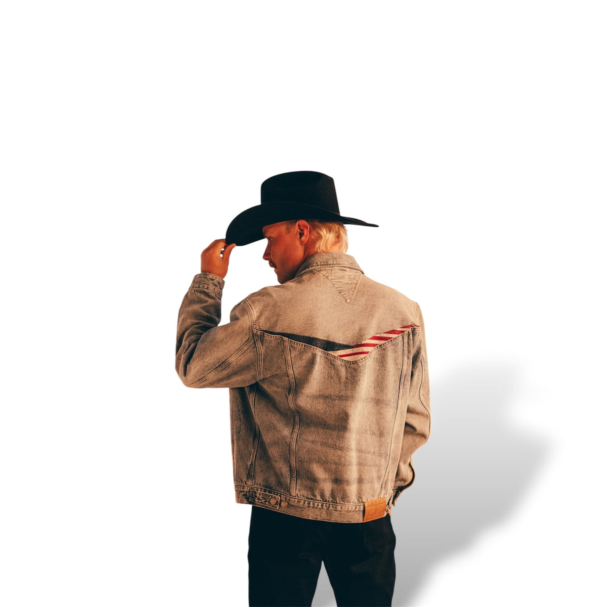 Back of a brown-toned denim jacket with a red, white, and navy V-shaped graphic