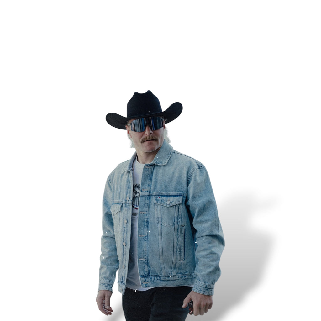 Light blue denim trucker jacket worn with front button closure and flap chest pockets