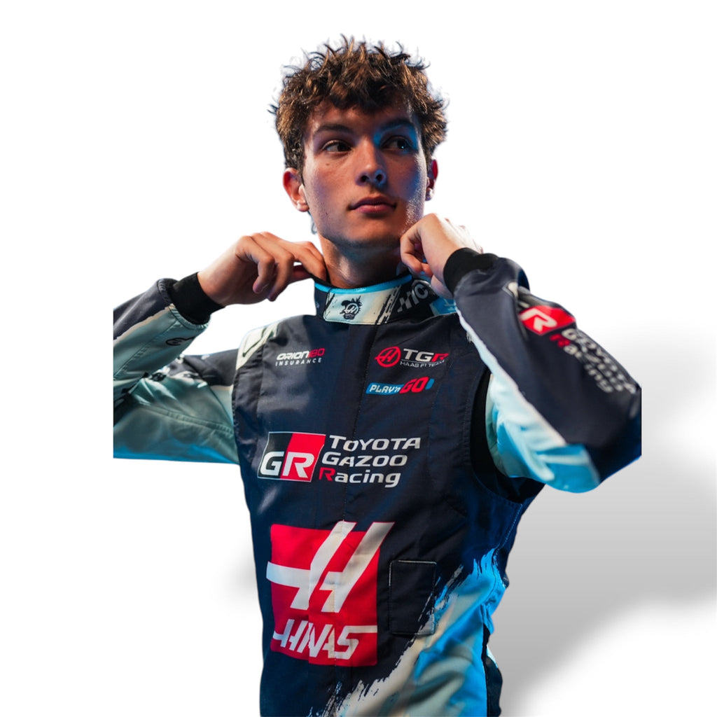 Haas F1 race suit upper-body view with prominent chest logos and blue side panels