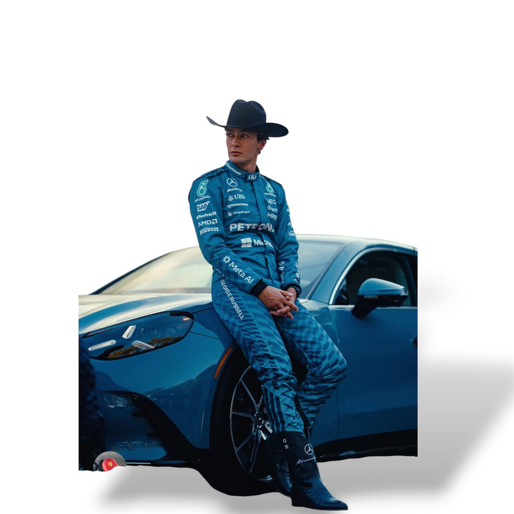 Light blue Mercedes Formula 1 race suit with sponsor logos, worn while sitting on a car