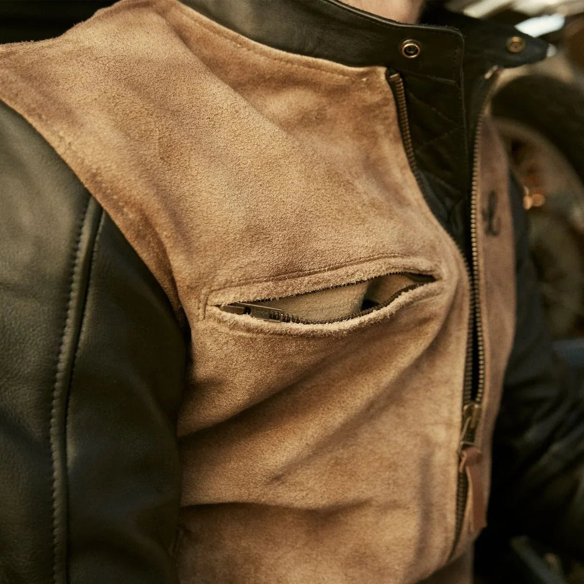 Close-up of the jacket's horizontal zip chest pocket