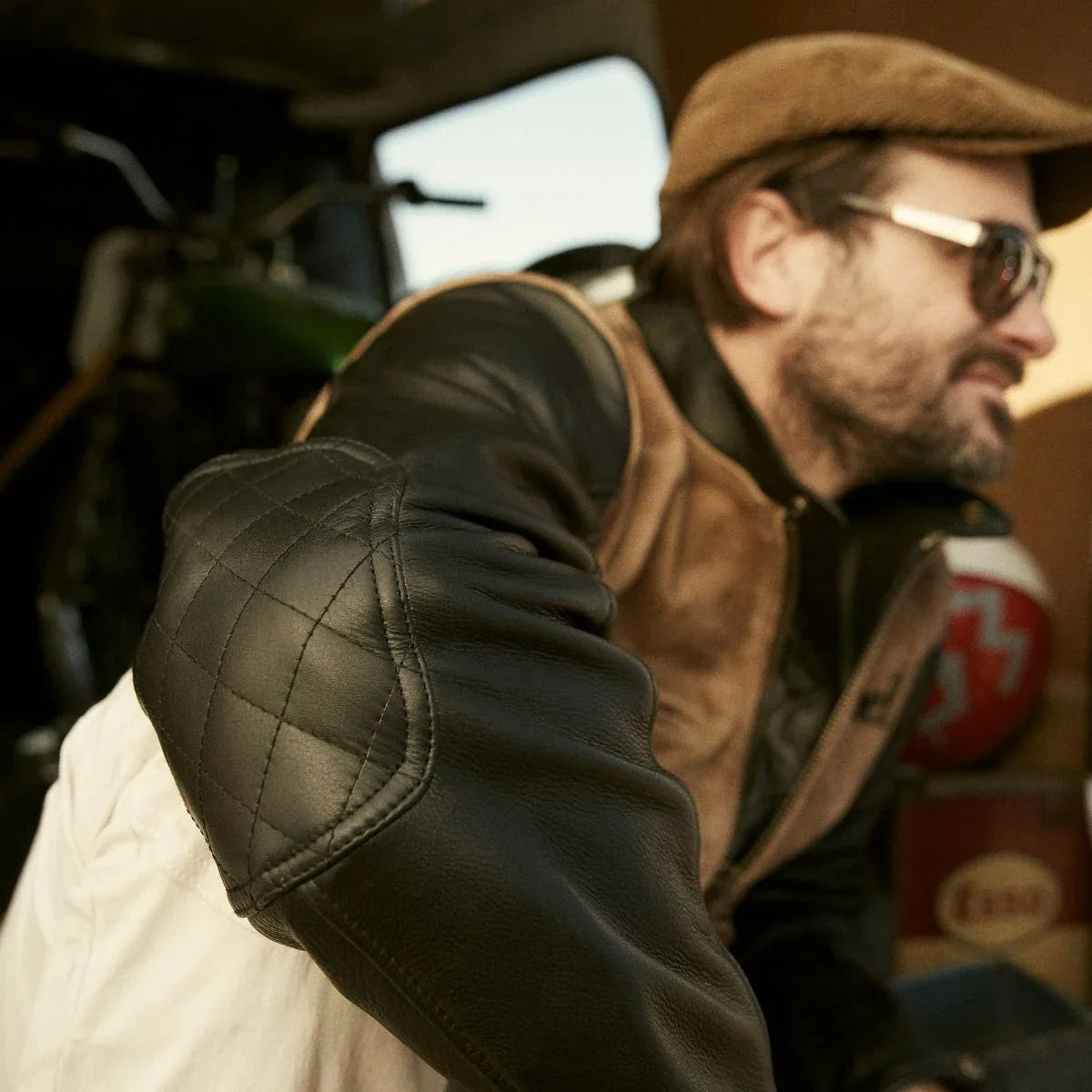 Fuel Sidewaze leather jacket worn, showing black sleeves with quilted elbow panels and tan body.