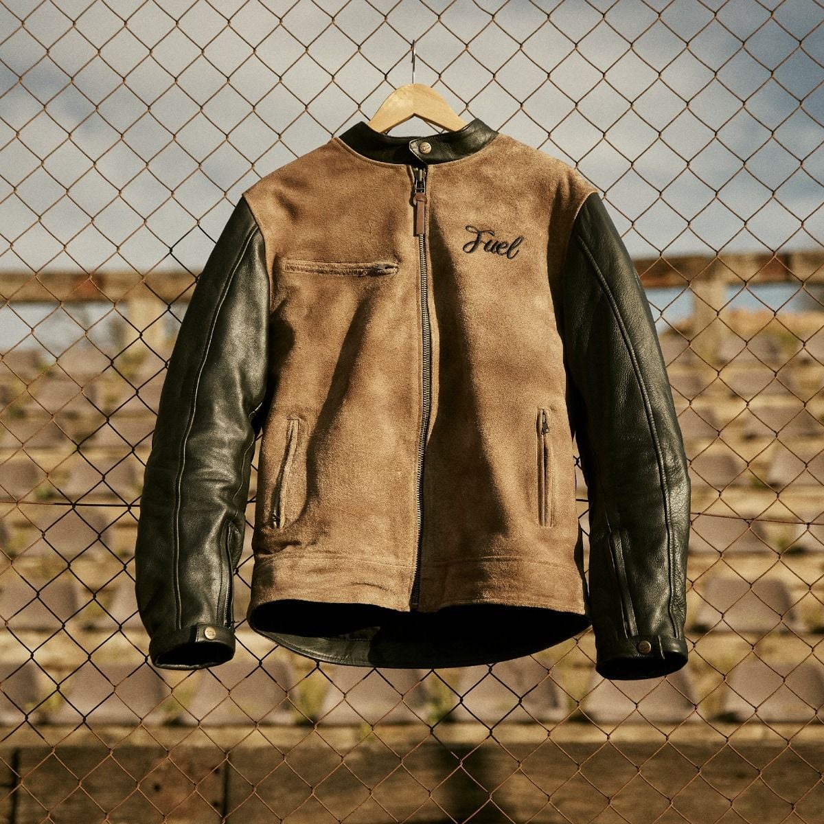 Fuel Sidewaze leather jacket, front view, with a tan body, black sleeves, zip pockets, and chest logo.