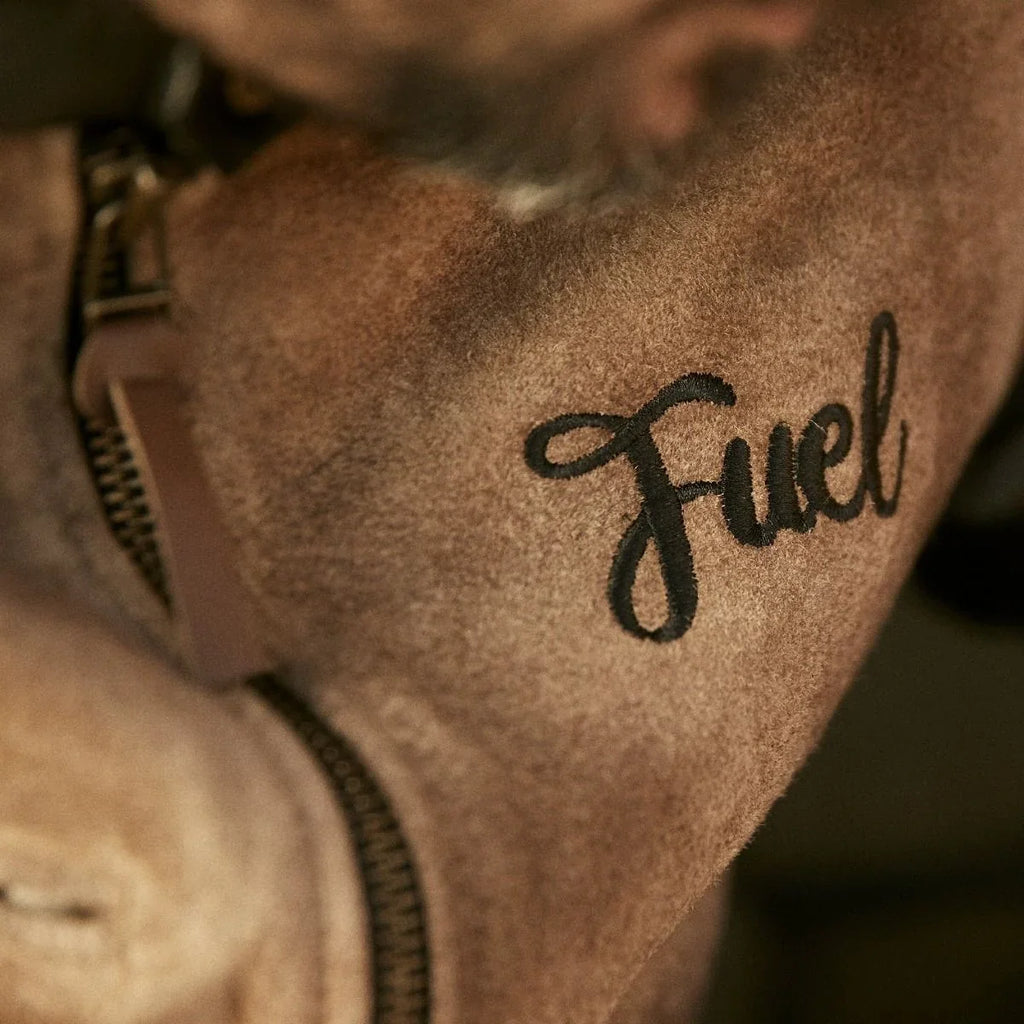 Close-up of Fuel embroidery and zipper on the tan suede jacket