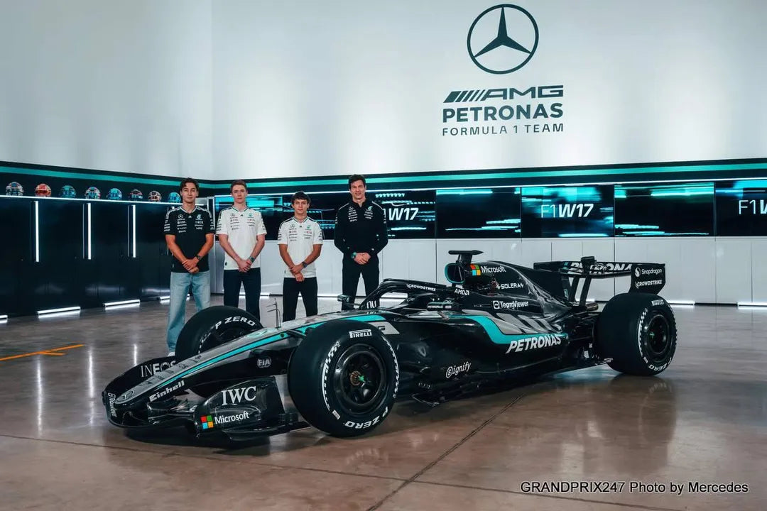 Mercedes AMG Petronas Formula 1 car with team members in a garage setting. - Endless Racewear