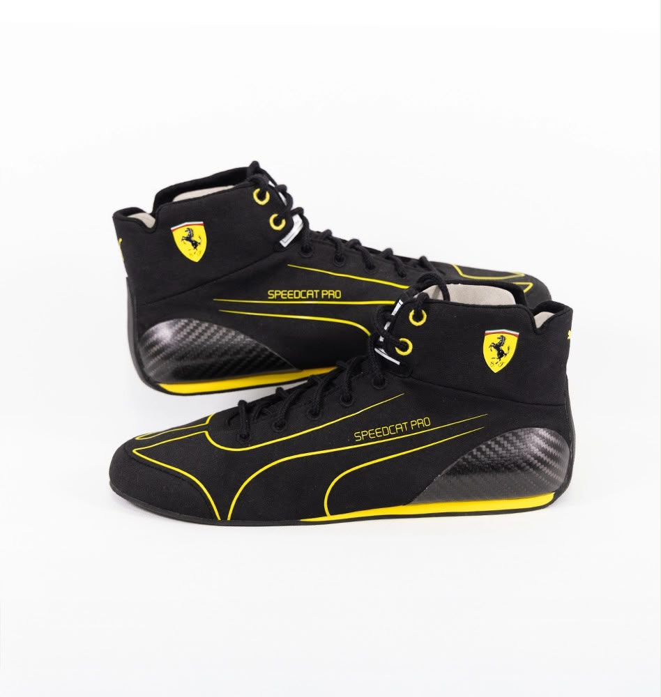 Black high-top race shoes with yellow trim, Ferrari shield, lace-up and textured panels