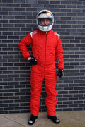 Red racing suit with white helmet, black gloves and boots